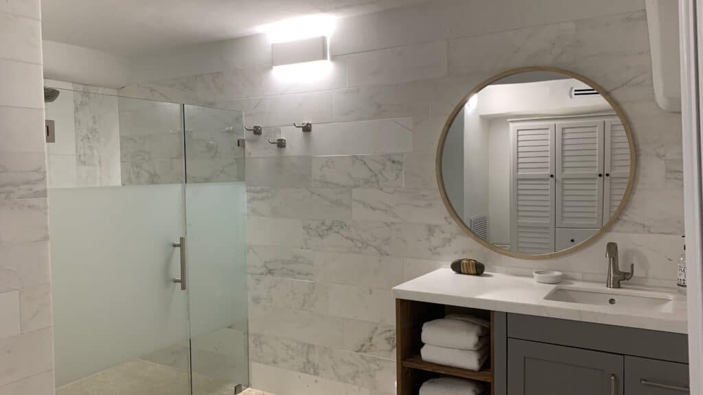 Immaculate bathroom with gleaming fixtures and a pristine shower.