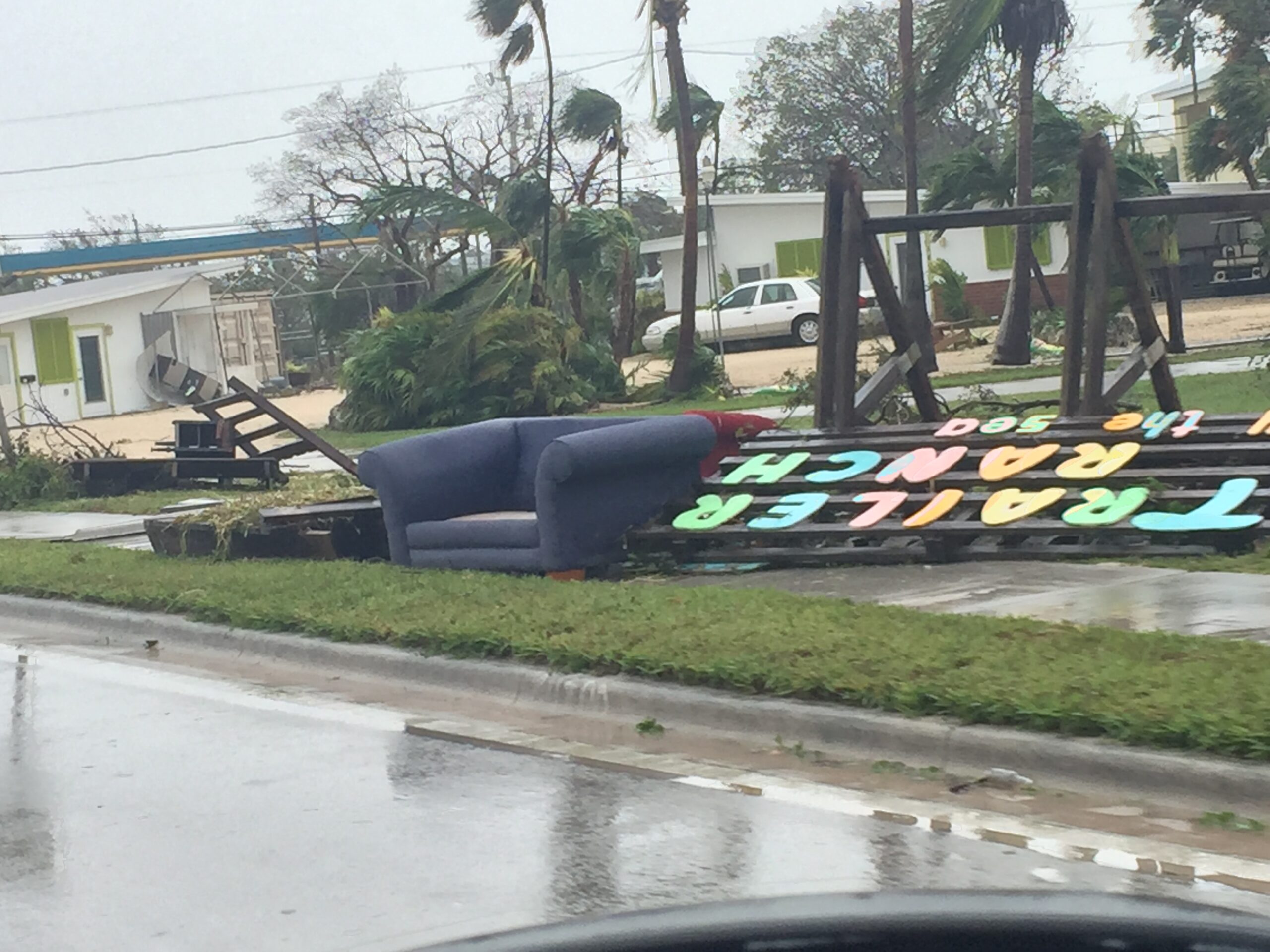 Property damage from hurricane showing fallen trees and scattered debris