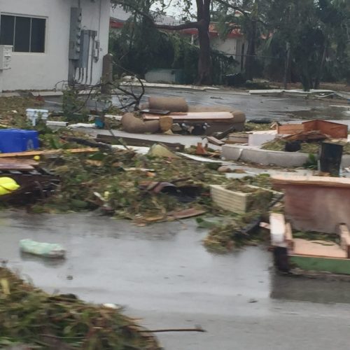 Hurricane damage aftermath showing debris scattered across property