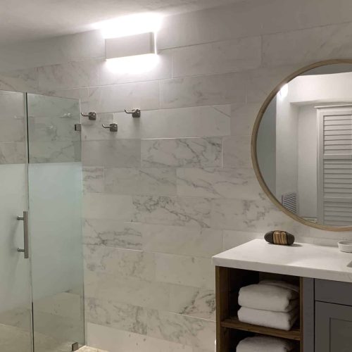 Immaculate bathroom with gleaming fixtures and a pristine shower.