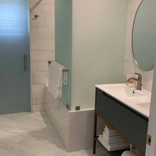 Immaculate bathroom with gleaming fixtures and a pristine shower.